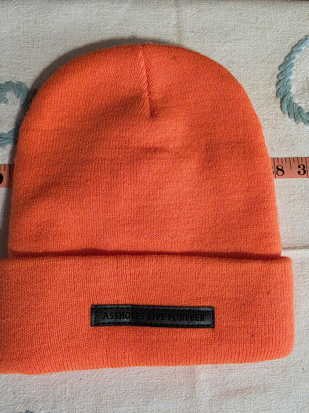 Bold Orange Knit Beanie with Black Leather Logo Patch